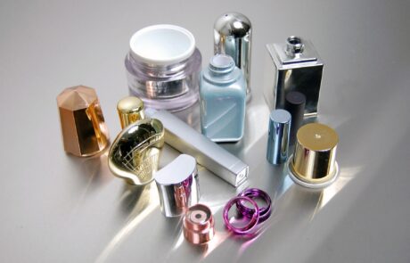 Cosmetic caps and closures with decorative vacuum metalized Cosmetic caps and closures with decorative vacuum metalized chrome and color finishes
